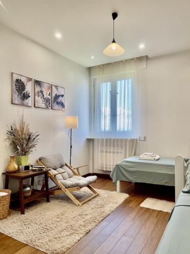 a living room with a chair and a bed at Happy Nest Tuscany in Castiglion Fiorentino