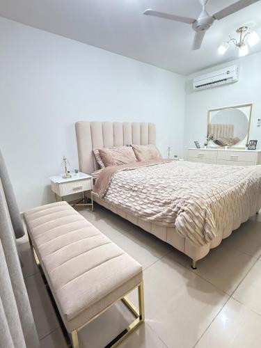 a bedroom with a large bed and a mirror at Opera47 Spacious & Central in Ghubrah