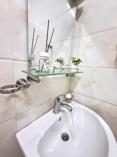 a bathroom with a sink and a mirror at Opera47 Spacious & Central in Ghubrah