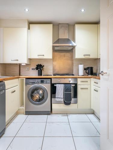 a kitchen with a washer and dryer at Truvana Haven in Coundon