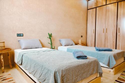 two beds sitting in a room withermottermottermott at Cool Surfers Morocco in Agadir
