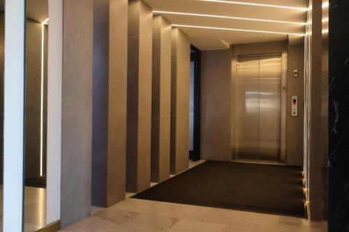 a hallway with a elevator in a building at Seven Crown La Paz Malecon in La Paz