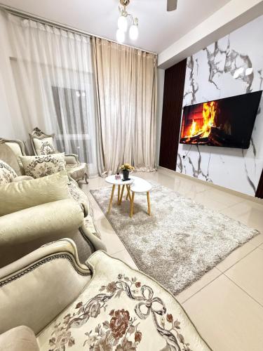 a living room with a couch and a fireplace at Opera67 Spacious & Central in Ghubrah