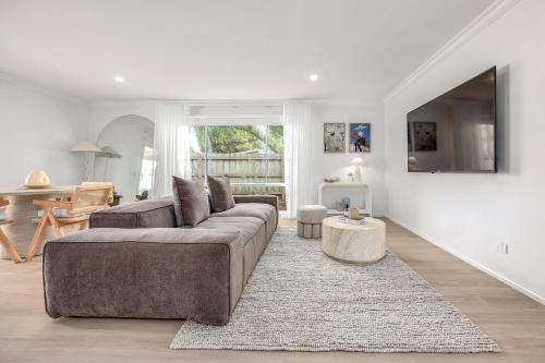a living room with a couch and a table at 5 min walk to beach, 5 min drive to shops in Capel Sound
