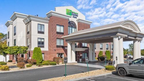 a hotel with a car parked in front of it at Holiday Inn Express Hotel & Suites Manchester - Airport by IHG in Manchester