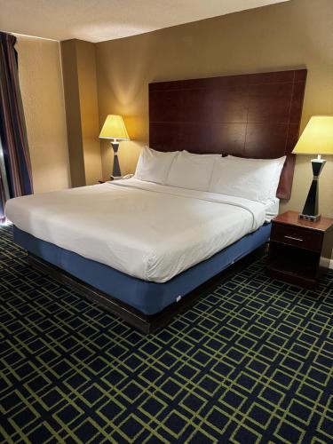 a large bed in a hotel room with two lamps at Barclay Hotel Atlanta Downtown in Atlanta