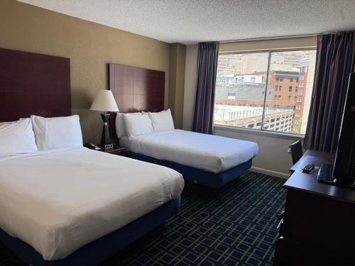 a hotel room with two beds and a window at Barclay Hotel Atlanta Downtown in Atlanta