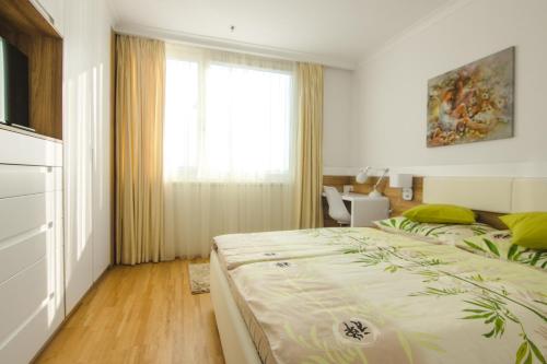 a bedroom with a large bed and a window at Vienna Apartments Hauptbahnhof in Vienna