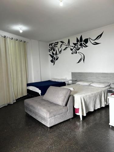 Hotel Roma Edeia tesisinde bir odada yatak veya yataklar