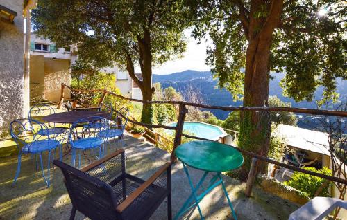 een balkon met tafels en stoelen en uitzicht op de bergen bij Lovely Home In Lugo Di Nazza in Lugo-di-Nazza