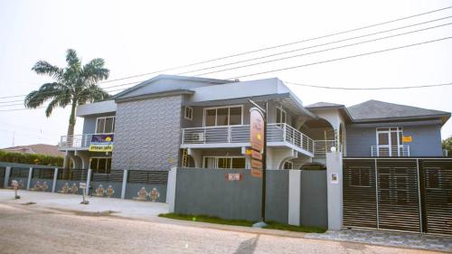 a house with a fence in front of it at Home from Home Ghana in Accra