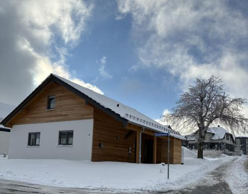 a wooden building with snow on the ground at Schneekopfblick in Oberhof