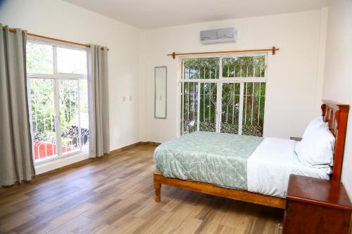 a bedroom with a bed and a large window at Casa Naranja in Ciudad Fernández