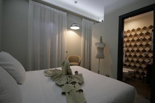 a bedroom with a white bed with a bow on it at B&B Sinfonia Sul Tevere in Rome