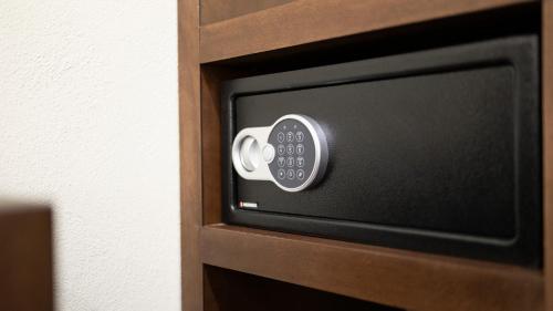 a television with a remote control on a wooden door at MC HOTEL Saldarriaga Querétaro in Querétaro
