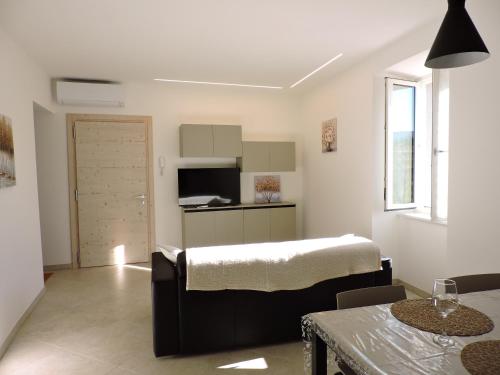 een woonkamer met een bed en een keuken bij L'Ora del Bianco in Nave San Felice