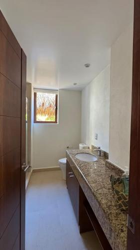 a bathroom with a sink and a toilet at Palmetto 2-story Luxury condos in Ixtapa