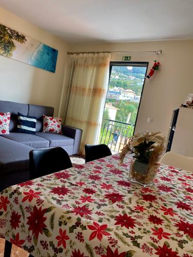 a living room with a table with a blanket on it at Casa Gomes in Calheta