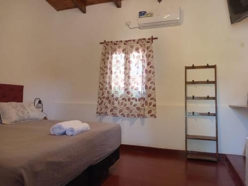 a bedroom with a bed and a window at El descanso de la Furia in La Porteña