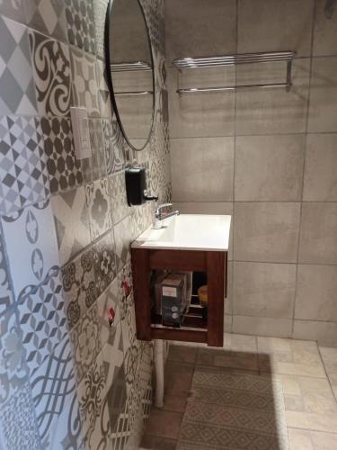 a bathroom with a sink and a mirror at El descanso de la Furia in La Porteña