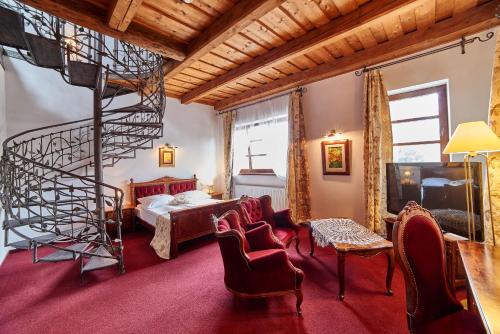 a bedroom with a spiral staircase and a bed at Folwark Stara Winiarnia in Mszana Dolna