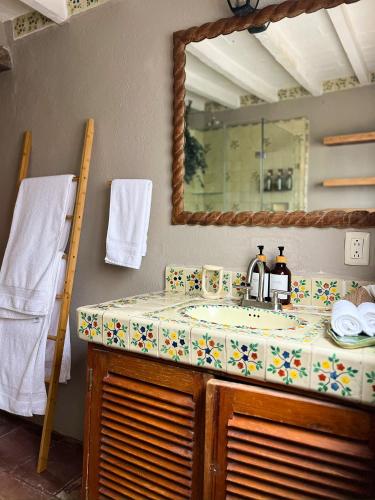 a bathroom with a sink and a mirror at Ombligo Connection House in Valle de Bravo