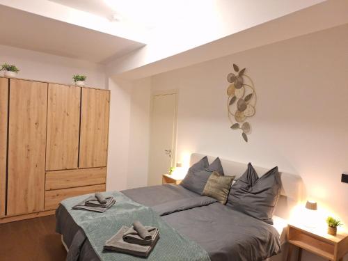 a bedroom with a bed with two towels on it at SPA & SOUL Residence Neusiedl am See in Neusiedl am See