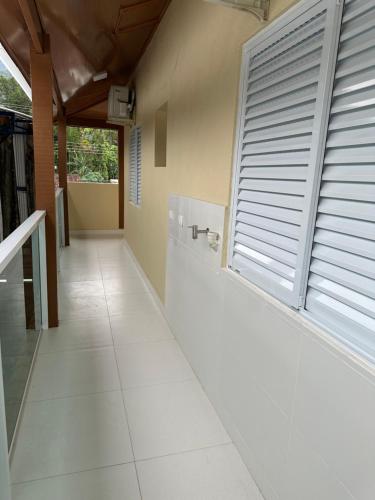 a hallway with a large window and a tile floor at Chalés Brisa Do Mar in São Sebastião