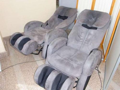 a group of empty chairs sitting in a room at Atami Hotel Paipuno Kemuri in Atami