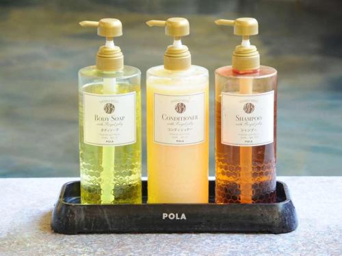 three bottles of oil on a black tray at Atami Hotel Paipuno Kemuri in Atami