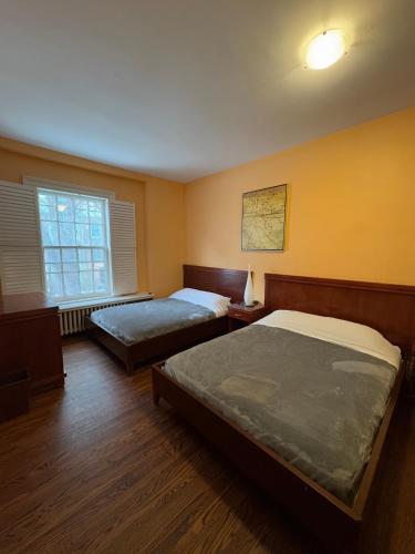 a bedroom with two beds and a window at 49 Hostel in Toronto