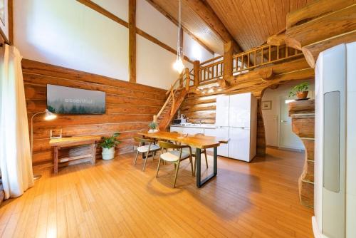 a kitchen and dining room with a table and a refrigerator at Yangpyeong Evergrove in Yangpyeong
