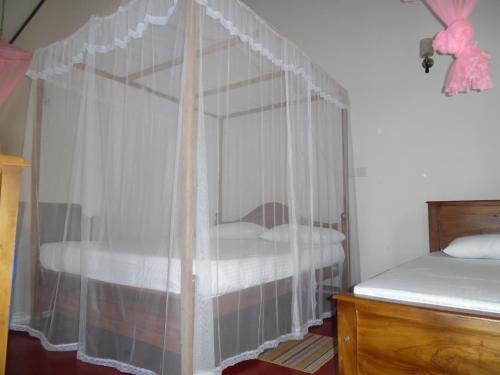 A bed or beds in a room at Mount View Villa Resort Mirissa