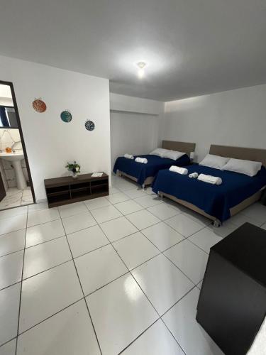 a room with two beds and a table in it at Harmony Inn Miraflores in Lima