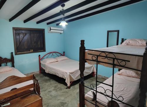 Llit o llits en una habitació de El Oasis Posada