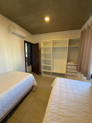 a bedroom with two beds and a closet at Bello departamento en Encarnación de 2 Habitaciones con Parking! in Encarnación