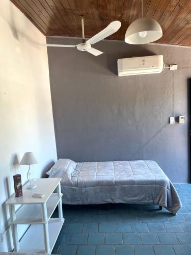 a bedroom with a bed and a ceiling fan at Monoambiente Noah 2 in Ezeiza