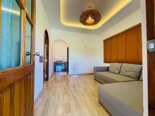 a living room with a couch and a ceiling at Baan Sangchan in Ko Kood