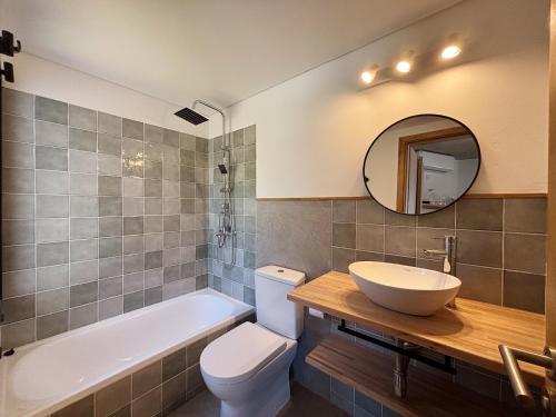 a bathroom with a sink and a tub and a toilet at Casa Jacana in Maldonado