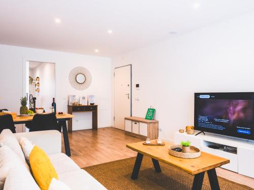 a living room with a couch and a tv at Moodhu Villa - Cozy Apart w/ Amazing Terrace in Leiria