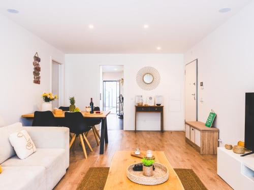 a living room with a couch and a table at Moodhu Villa - Cozy Apart w/ Amazing Terrace in Leiria
