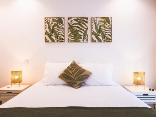 a bedroom with a white bed with two lamps at Moodhu Villa - Cozy Apart w/ Amazing Terrace in Leiria