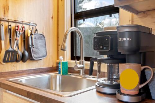 a coffee maker sitting on a kitchen counter next to a sink at Cozy ski cabin #3, 3 beds in Bethel