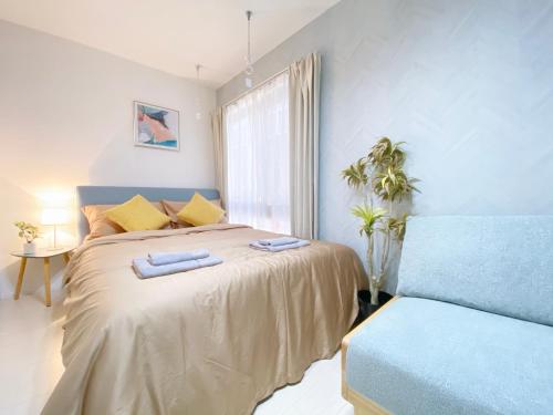 a bedroom with a large bed and a window at nestay apartment tokyo ginza in Tokyo