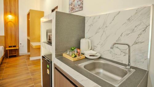 a kitchen with a sink and a counter top at O k Chawkoh Bungalow in Ko Lanta