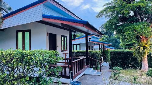 a small house with a staircase in front of it at Baan Sangchan in Ko Kood