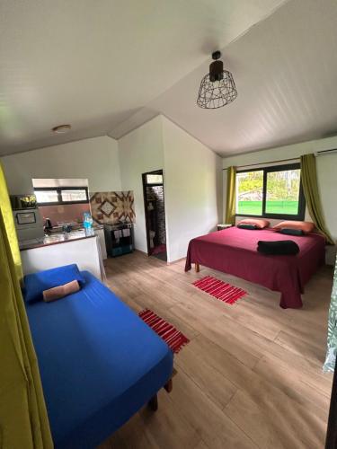 a bedroom with two beds and a couch in it at Ori Lodge Rangiroa in Rangiroa