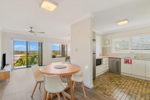 a kitchen and dining room with a table and chairs at Endless Horizon in Kingscliff