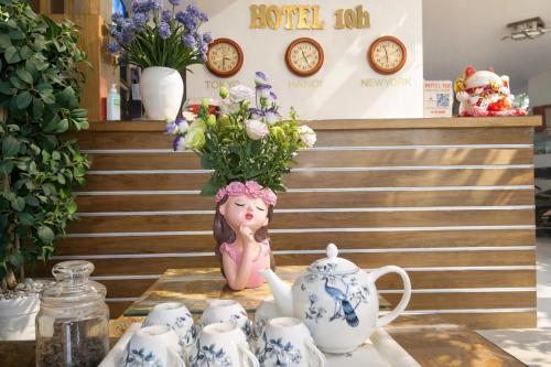 a table topped with blue and white cups and a vase at 10h Hotel in Ho Chi Minh City