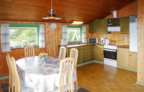 a kitchen with a table and chairs in a room at Holiday Home Mågevej Rømø Iv in Rømø